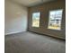 Bedroom with neutral carpeting, two large windows, and ample space at 3908 Shelleydale Dr # 39, Powder Springs, GA 30127