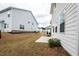 Backyard showcasing a concrete patio, lush greenery, and the home's exterior at 3739 Silvery Way, Powder Springs, GA 30127