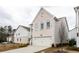 Charming two-story home with white painted brick, attached garage, and meticulously manicured lawn and driveway at 3739 Silvery Way, Powder Springs, GA 30127
