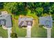 Birds-eye view of a home with a pristine lawn, mature trees, driveway, and backyard deck at 658 Eight Point Ct, Suwanee, GA 30024