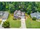 Aerial view of a beautiful two-story home with lush green landscaping and mature trees at 658 Eight Point Ct, Suwanee, GA 30024