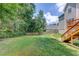 Expansive backyard with lush green grass and stairs to upper deck at 658 Eight Point Ct, Suwanee, GA 30024
