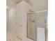 Bright bathroom featuring a glass enclosed shower with tile, and a tile floor at 658 Eight Point Ct, Suwanee, GA 30024