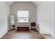 Bright bedroom featuring hardwood floors, a window with a backyard view, and decor at 658 Eight Point Ct, Suwanee, GA 30024