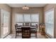 Bright breakfast nook with a wooden table set, large window, and a view to the outside at 658 Eight Point Ct, Suwanee, GA 30024