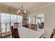 Bright dining room with wood floors, a decorative chandelier, and a view to the entryway at 658 Eight Point Ct, Suwanee, GA 30024