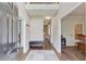 Inviting entryway with wood floors, a bench, and a view of the dining room at 658 Eight Point Ct, Suwanee, GA 30024