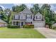 Charming two-story home with a well-manicured lawn, trimmed hedges, and a two-car garage at 658 Eight Point Ct, Suwanee, GA 30024