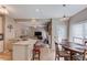 Spacious kitchen flows into the living room, featuring granite countertops and open-concept design at 658 Eight Point Ct, Suwanee, GA 30024