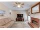 Comfortable living room with a brick fireplace, a large TV, and soft lighting at 658 Eight Point Ct, Suwanee, GA 30024