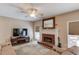 Cozy living room with a brick fireplace, TV, and comfortable seating at 658 Eight Point Ct, Suwanee, GA 30024
