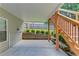 Covered patio leads to backyard with stairs to the second floor deck at 658 Eight Point Ct, Suwanee, GA 30024