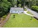 Aerial view of a blue house with a spacious front yard and mature trees at 2830 Alston Drive Se Dr, Atlanta, GA 30317