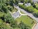 An aerial view highlighting the manicured lawn and lush tree coverage of this home at 2830 Alston Drive Se Dr, Atlanta, GA 30317
