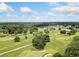 Aerial view of a golf course with lush green fairways, trees, and a serene lake at 2830 Alston Drive Se Dr, Atlanta, GA 30317