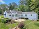 Landscaped backyard with patio, sunroom, and well-maintained lawn at 2830 Alston Drive Se Dr, Atlanta, GA 30317