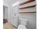 Bathroom view of floating shelves, sink, toilet, and tiled floor at 2830 Alston Drive Se Dr, Atlanta, GA 30317