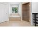 Bathroom with tub and frameless shower, with tile surround and natural light at 2830 Alston Drive Se Dr, Atlanta, GA 30317