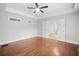 Bedroom featuring hardwood floors, tray ceilings, and a bathroom ensuite at 2830 Alston Drive Se Dr, Atlanta, GA 30317