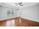 Spacious bedroom with hardwood floors, tray ceilings, and natural light from large windows at 2830 Alston Drive Se Dr, Atlanta, GA 30317