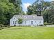 Charming light-blue home with a well-maintained lawn and manicured landscaping at 2830 Alston Drive Se Dr, Atlanta, GA 30317