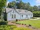Charming blue home with manicured lawn and landscaping enhances curb appeal at 2830 Alston Drive Se Dr, Atlanta, GA 30317