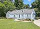 Quaint home with manicured lawn, wrought iron fence, and mature landscaping at 2830 Alston Drive Se Dr, Atlanta, GA 30317