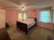 Inviting bedroom with carpeted floors, a comfortable bed and a ceiling fan at 4402 Autumn Hill Drive, Stone Mountain, GA 30083