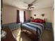 Comfortable bedroom with a ceiling fan, neutral decor and soft natural light from large window at 4402 Autumn Hill Drive, Stone Mountain, GA 30083