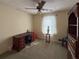 Bedroom featuring carpet, a desk and a ceiling fan for comfort with great natural light at 4402 Autumn Hill Drive, Stone Mountain, GA 30083