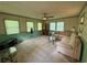Cozy living room with plush carpet, abundant natural light and a comfortable seating area at 4402 Autumn Hill Drive, Stone Mountain, GA 30083