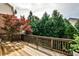 Outdoor wooden deck surrounded by lush greenery and mature trees, creating a private backyard retreat at 11760 Stratham Dr, Alpharetta, GA 30009