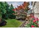 Manicured backyard with lush landscaping and a private deck at 11760 Stratham Dr, Alpharetta, GA 30009