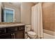 Bathroom with granite vanity, neutral tile, and shower-tub combination with shower curtain at 11760 Stratham Dr, Alpharetta, GA 30009