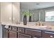 Modern bathroom with double vanity, granite countertop, and decorative mirror at 11760 Stratham Dr, Alpharetta, GA 30009