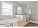 Luxurious bathroom featuring a soaking tub and glass-enclosed shower at 11760 Stratham Dr, Alpharetta, GA 30009