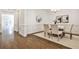 Bright dining room featuring hardwood floors, wainscoting, modern lighting, and elegant decor at 11760 Stratham Dr, Alpharetta, GA 30009