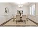 Bright dining room features a modern light fixture, wainscoting, and shuttered windows at 11760 Stratham Dr, Alpharetta, GA 30009
