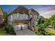 Charming two-story home featuring a two-car garage and beautifully landscaped front yard with stone and siding accents at 11760 Stratham Dr, Alpharetta, GA 30009
