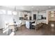 Open concept kitchen and dining area with a granite island, stainless appliances, and hardwood flooring at 11760 Stratham Dr, Alpharetta, GA 30009