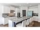 Modern kitchen with a large island, granite countertops, stainless steel appliances, and white cabinetry at 11760 Stratham Dr, Alpharetta, GA 30009