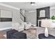 Stylish living room with a dark fireplace, modern furnishings, and a view of the staircase at 11760 Stratham Dr, Alpharetta, GA 30009