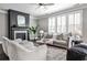 Comfortable living room with a fireplace, built-ins, shuttered windows, and neutral decor at 11760 Stratham Dr, Alpharetta, GA 30009