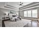 Spacious main bedroom featuring a tray ceiling, hardwood floors, and large windows offering ample natural light at 11760 Stratham Dr, Alpharetta, GA 30009