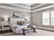 Bright main bedroom boasts a plush rug, bench, and stylish decor at 11760 Stratham Dr, Alpharetta, GA 30009