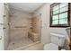 Bathroom featuring tiled walk-in shower, shower seat, and sturdy grab bars for added safety and convenience at 41 Ridgewood Cir, Mcdonough, GA 30252