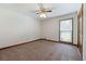 Bedroom with carpet, window allowing natural light, ceiling fan, and door at 41 Ridgewood Cir, Mcdonough, GA 30252