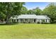 Charming single-story home with a well-manicured lawn and mature trees, offering classic curb appeal at 41 Ridgewood Cir, Mcdonough, GA 30252