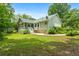 Back exterior of house with screened porch, yard, stone accents, and garage at 41 Ridgewood Cir, Mcdonough, GA 30252