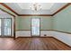 Living room with hardwood floors and white walls with trimmed windows and doors at 41 Ridgewood Cir, Mcdonough, GA 30252